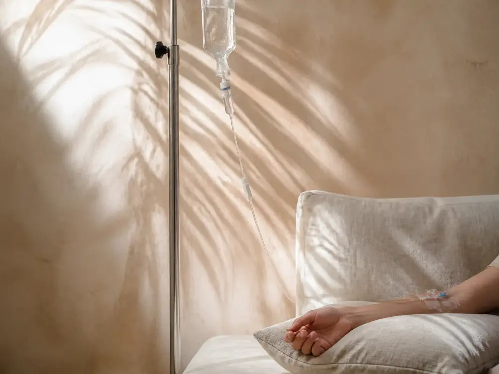 IV bag beside a daybed in window light
