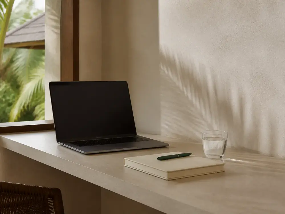 Laptop and notebook on a villa desk